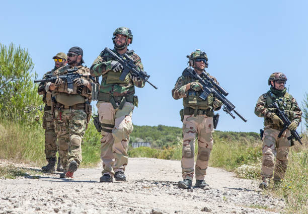 istock Army soldiers running on road in abandoned area 1264085154