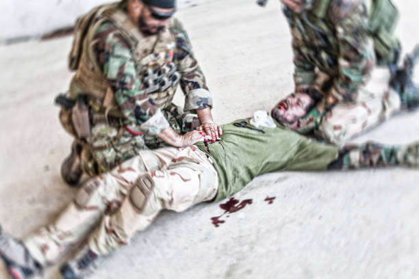 istock Soldier giving emergency care to wounded comrade 1264085157