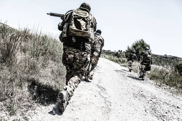 istock Army soldiers running on road in abandoned area 1264085162