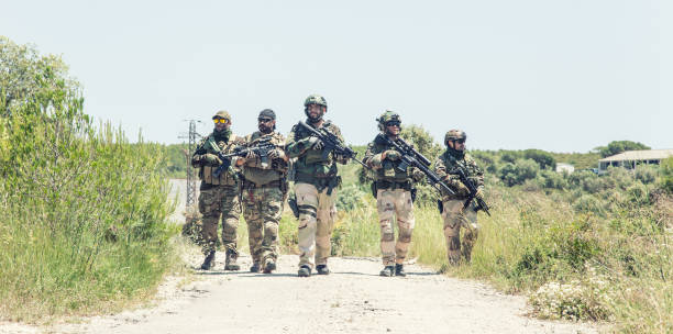 istock Army soldiers running on road in abandoned area 1264085204