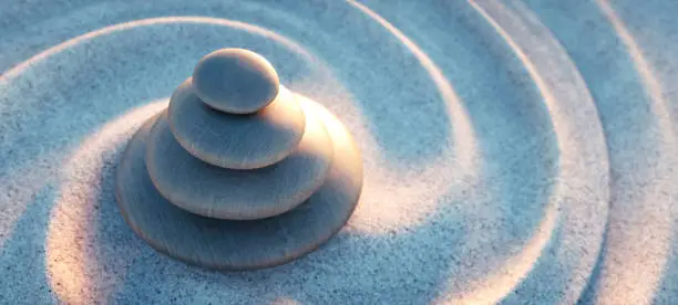 Stack of pebbles with spiral sand waves