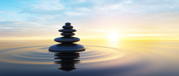 Stack of Stones in the ocean Stack of Stones in calm water with evening clouds wellness stock pictures, royalty-free photos & images