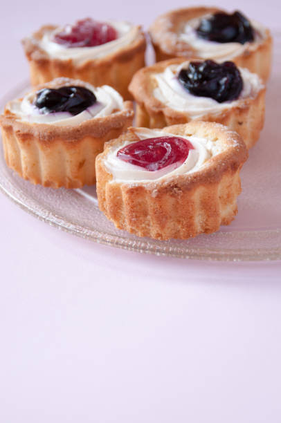 istock Cookies with jam on a transparent plate on a pink background, space for text 1264088042