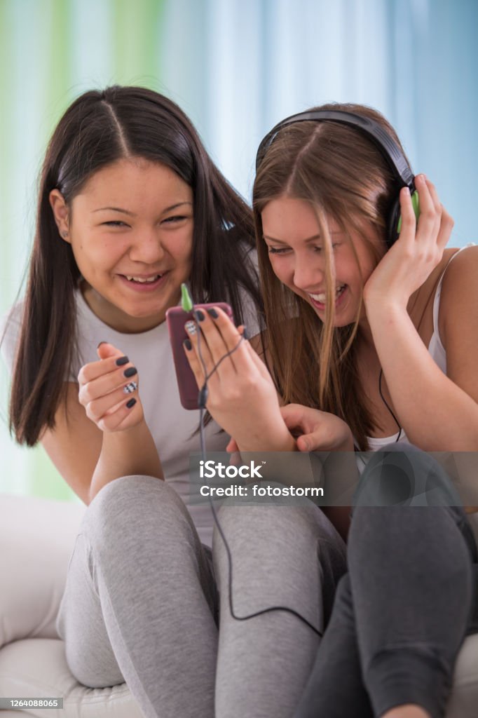 Giggling While Watching A Funny Video Stock Photo - Download Image Now -  Indoors, Laughing, Living Room - iStock