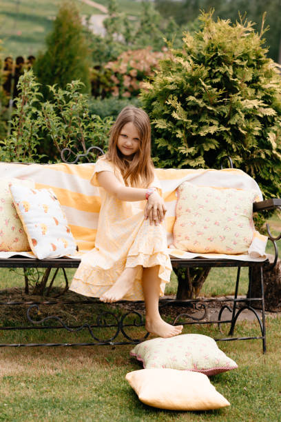 istock The child is resting in the fresh air sitting on a bench. 1264089585