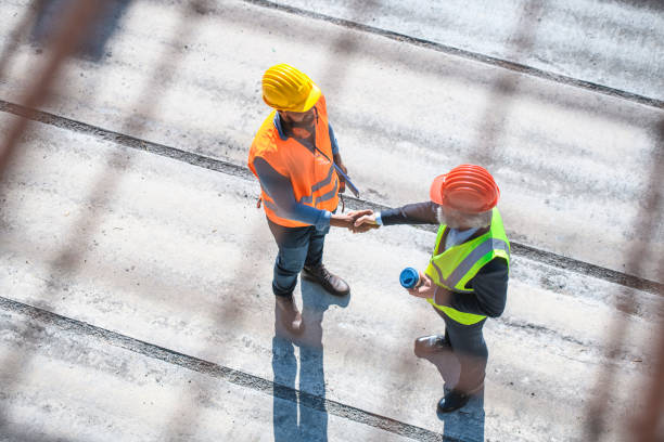 istock African Construction Site Foreman Greeting Caucasian Manager 1264090419