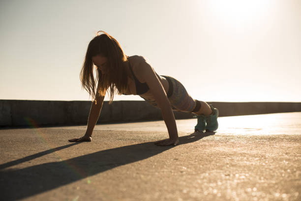 istock Fit woman doing exercises on summer sunset 1264091013