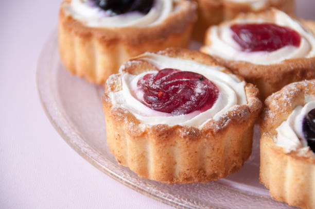 istock Cookies with jam on a transparent plate on a pink background 1264091275