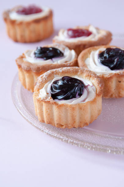 istock Cookies with jam on a transparent plate on a pink background, space for text 1264091409