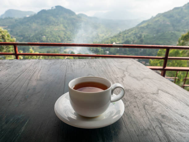 istock Tea cup on table above tea plantations in Sri Lanka 1264091412