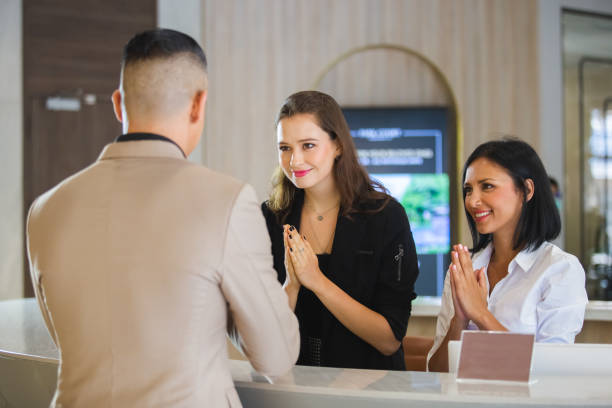 istock Receptionist hotel greeting thailand style for visitor check In Formal. 1264092035