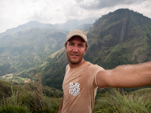 istock Man takes selfie photo on mountain top 1264092037