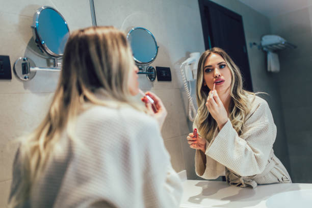 istock Young woman makes her makeup in bathroom 1264094306