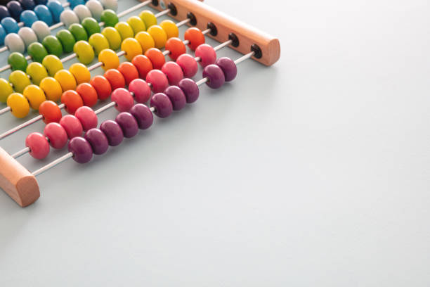 istock School abacus with colorful beads on blue color background, close up view 1264095069