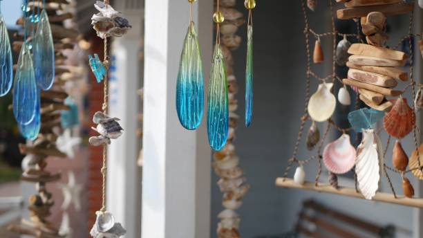 istock Nautical style hanging seashells decoration, beachfront blue wooden holiday home, pacific coast, California USA. Marine pastel interior decor of beach house in breeze. Summertime sea wind aesthetic 1264095320