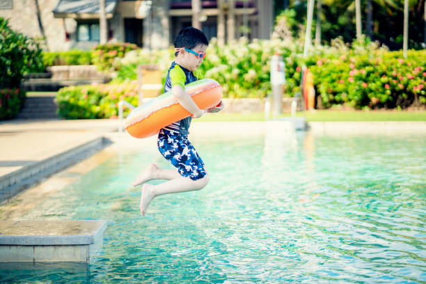 Little boy ready to jump into the swimming pool