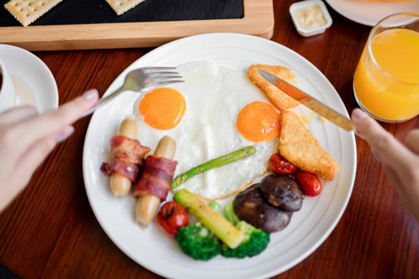 Multigrain toast with fried egg and roasted tomatoes and  sausage roll