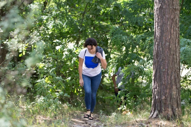 istock Young woman walks in the summer forest. 1264095698