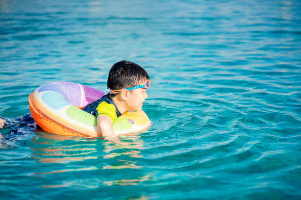 istock Little asian boy swimming in the pool 1264095801