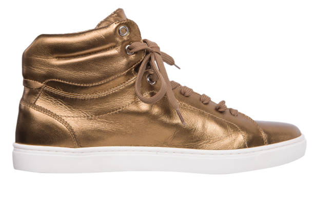 istock Golden leather PVC shoe with white platform Sneaker on White background, studio. 1264095932