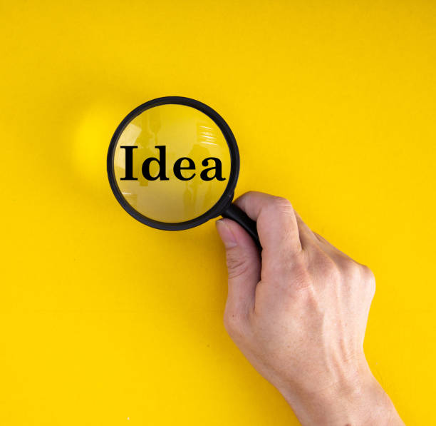 istock Creative idea and innovation concept with magnifier on yellow background 1264097237