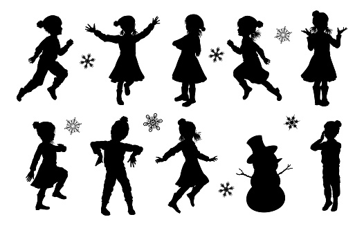 A set of children in silhouette playing having fun in Christmas or winter cold weather clothing
