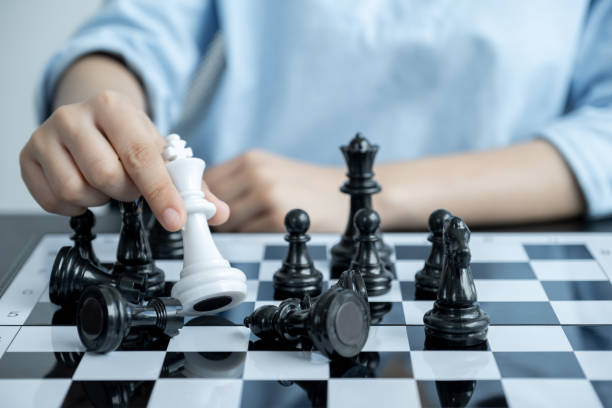 istock hand move chess with strategy and tactic to win enemy, play battle on board game, business opportunity  competition strategic challenge concept 1264101402