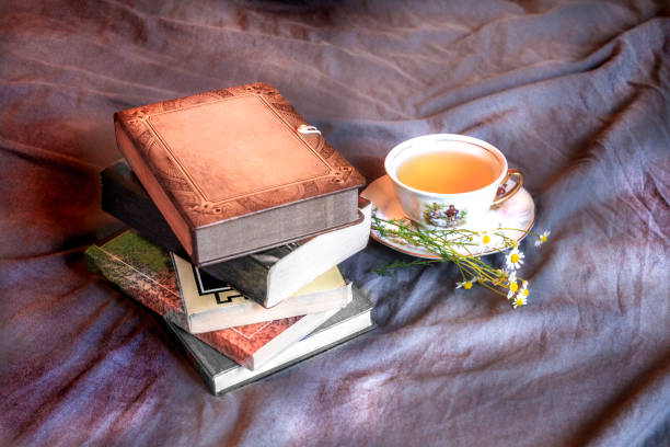 istock Books and cup of tea on the bed 1264101414