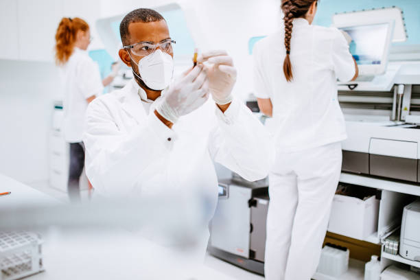 Scientists working in the laboratory Scientists working in the laboratory human centrifuge stock pictures, royalty-free photos & images