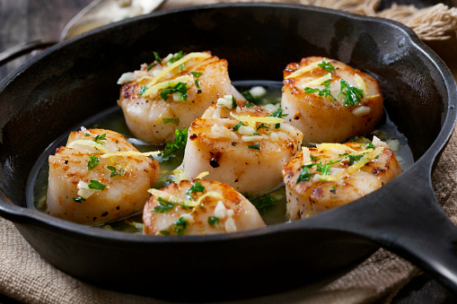 Scallops Poached in a Garlic Butter Sauce with Parsley and Lemon Zest