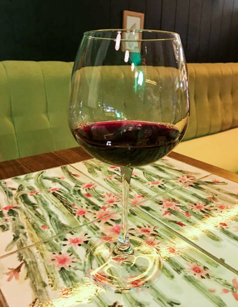 A glass of red wine on colorful table