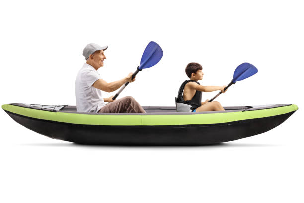 istock Boy and grandfather paddling in a canoe 1264106171