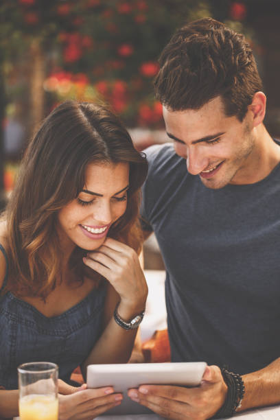 istock Couple ordering food from a digital tablet 1264107619