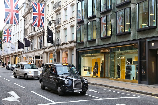 Fashion shops at New Bond Street in London. Bond Street is a major shopping street in the West End of London.