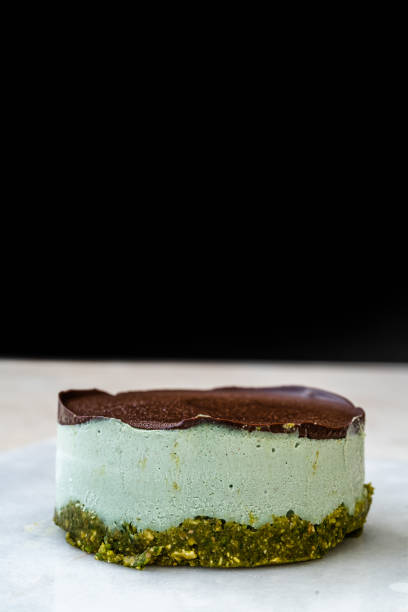 istock Vegan Raw Round Cheesecake with Mint, Bitter Chocolate and Pistachio Nut Paste. 1264109622