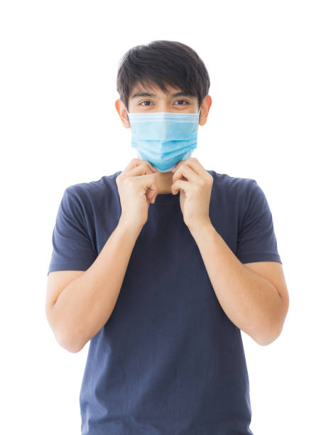 An Asian man wearing a mask to protect against viruses and PM 2.5 isolated on white background. stock photo