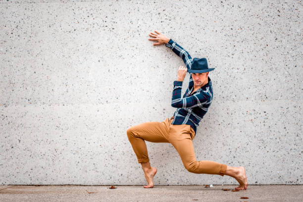 istock Male artist posing by the concrete wall 1264110899