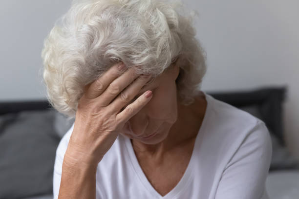istock Aged woman wakeup touches forehead feeling unwell suffer from headache 1264113525