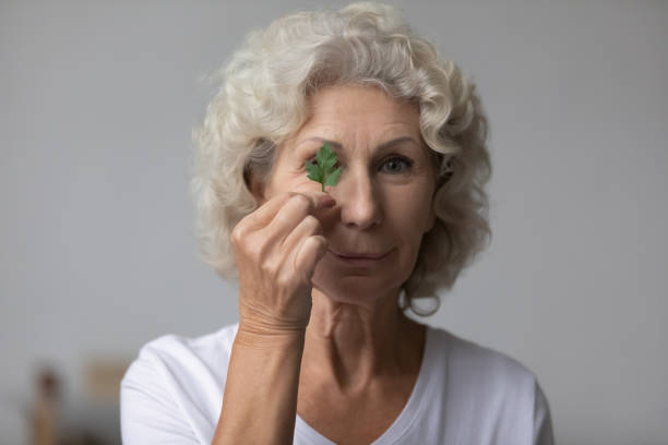 Elderly woman holding parsley natural herb looking at camera Head shot of mature woman hold parsley herb looks at camera. Skincare home natural treatment, caring for sensitive seniors skin, reduce wrinkles, increase skin regeneration, eco products cosmetics ad environmentalist photos stock pictures, royalty-free photos & images