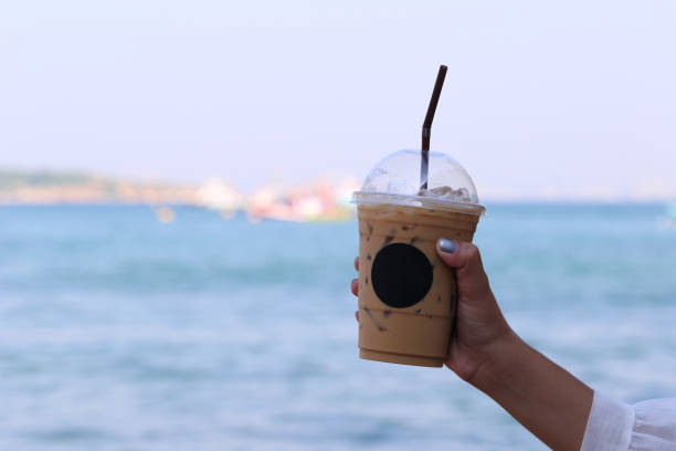 istock Woman hand holding cold coffee for summer drink 1264114054