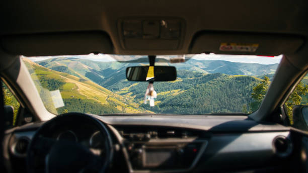 Winter landscape reflected in the car rear mirror