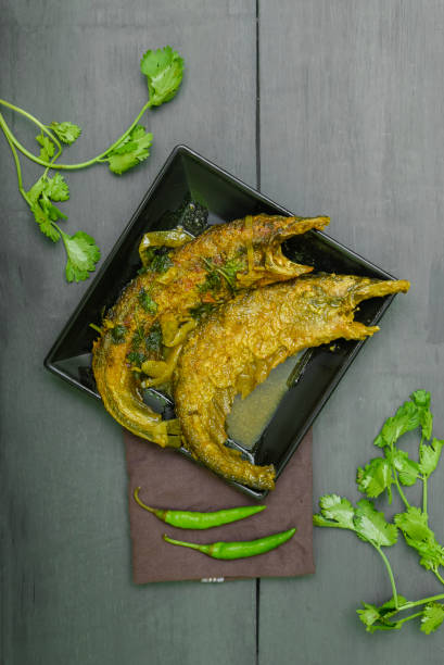 Pabda Macher Jhaal Sarse Bata Diye, Bengali mustard gravy based fish curry prepared with Pabda mach or Pabo Catfish Pabda Macher Jhaal Sarse Bata Diye, Bengali mustard gravy based fish curry prepared with Pabda mach or Pabo Catfish pabda fish stock pictures, royalty-free photos & images