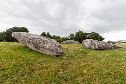 The Great Broken Menhir of Er Grah, located on the territory of the municipality of Locmariaquer, in Morbihan, is a menhir of exceptional dimensions, the largest in Europe: 18.5 m high when it was erected (20 , 4 m earthen part included), 3 m wide, estimated mass of 280 tonnes. This menhir, whose erection dates back to the middle of the 5th millennium BC. AD is now on the ground and broken into four pieces. It stood in the middle of a monumental ensemble exceptionally associating, in the same place, the three families of megalithic monuments: the Er Grah tumulus, the cairn of the Merchant's Table, the large broken menhir.