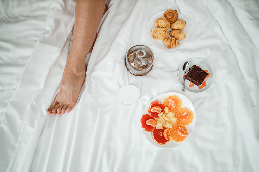 Freshly baked pastries, fruit and a cake for a breakfast in bed