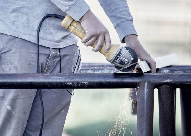 istock Man Cutting a Piece of Steel 1264128736