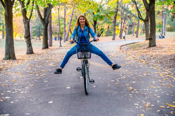 istock Woman riding bicycle with her legs in the air 1264129089