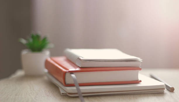 istock Workplace. Books, notebooks on the table opposite the window. Telework. Work at home. 1264130142