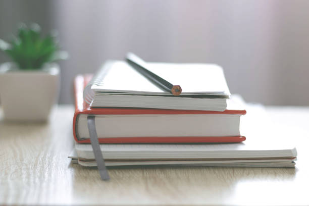 istock Workplace. Books, notebooks on the table opposite the window. Telework. Work at home. 1264130145