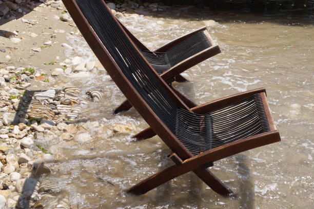 istock two empty wooden sun loungers on the seashore 1264130244