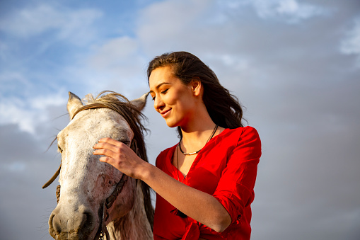 white horse and beautiful young woman.